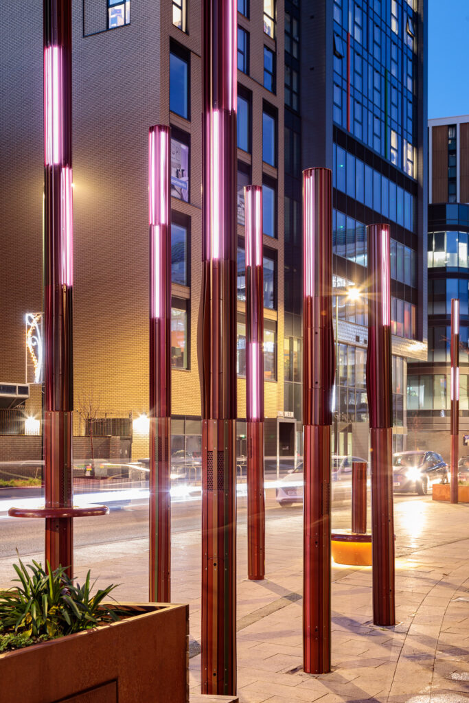 bespoke lighting design columns with integrated speaker system on the street, designed for immersive lighting experience